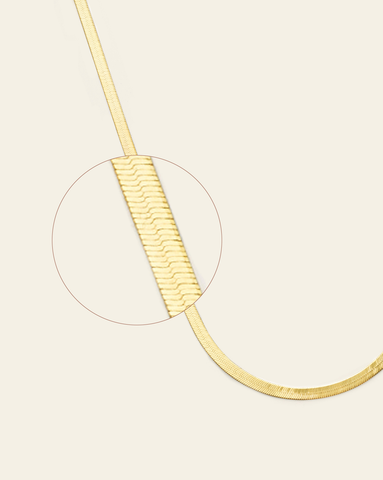 A magnified close up hero image of 3mm gold vermeil herringbone chain.