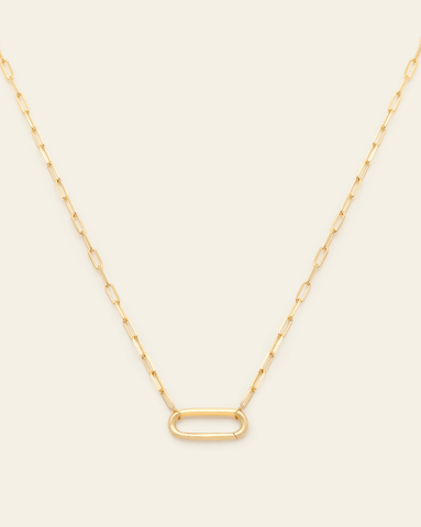 A Gold Vermeil staple link chain with a carabiner charm clasp on a cream background.