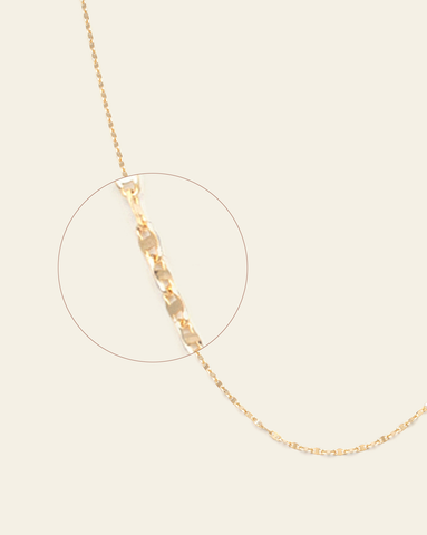 A magnified close up of solid gold fancy chain.