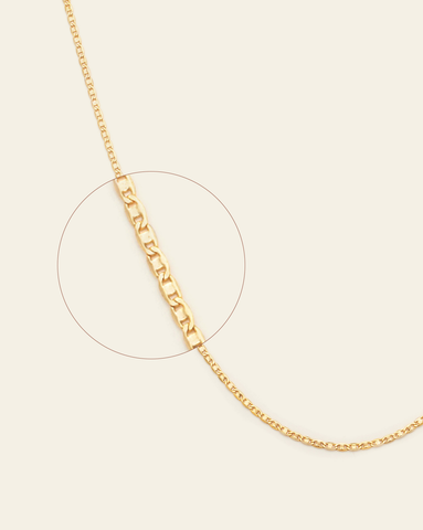 A magnified close up of gold vermeil golden glow chain.