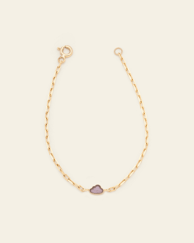 A photo of a Solid Yellow Gold thin staple chain bracelet with an Amethyst cloud charm in the centre against a cream background. 