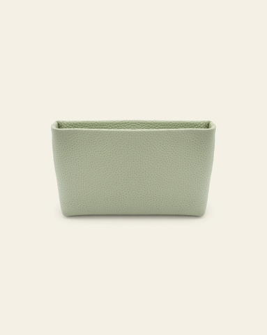 Hero image of Petite Essentials leather Pouch in Pistachio pebbled leather on cream background. 