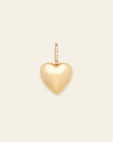 hero image of gold vermeil puffed heart pendant with CZ stones on cream background.