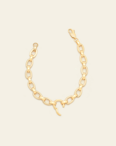 hero image of gold vermeil Sloane clasp bracelet on cream background. 