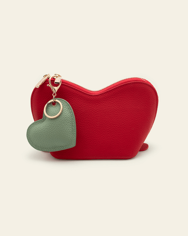 Image of cherry red heart pouch set against cream background