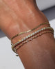 A video of a close up of a model’s wrist of the Perfect Serve Set in Gold Vermeil, featuring a flat mariner-style chain bracelet, a bezel set tennis bracelet with CZ stones, and a twisted rope chain bracelet.